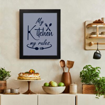 My Kitchen My Rules" kitchen wall art with a blue background, dark blue cursive text, and crossed fork and spoon icons. There is a vegetable table, and above it, there is wall art.