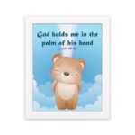 God Holds Me In The Palm Of His Hand Isaiah 49:16 Bible verse wall art for kids featuring a cartoon bear and fluffy clouds. hung on the wall in a white frame