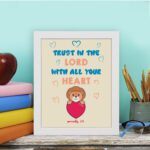 Cute teddy bear holding a heart with Trust in the Lord with all your heart text above, Proverbs 3:5 wall art design. displayed on the table in a white frame