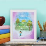 Wall art for kids featuring a child under a tree with the verse I will never leave you, I will never desert you from Hebrews 13:5. displayed on the table in a white frame