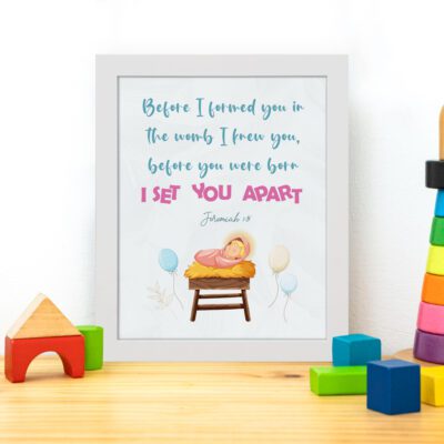 Baby in a crib with pastel balloons and Jeremiah 1:5 Bible verse, Before I Formed You in the Womb. Wall art for kids' room decor. displayed on the table in a white frame