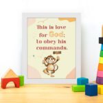 Cartoon monkey with 1 John 5:3 verse This is love for God: to obey His commands on beige and pink background. displayed on the table in a white frame