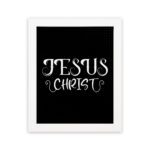 Jesus Christ wall art in white curly font on a black background, showcasing elegant Christian design. hung on the wall in a white frame