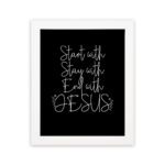 Christian wall art with the phrases Start With Jesus, Stay With Jesus, and End With Jesus in white text on a black background. hung on the wall in a white frame