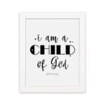 I Am A Child of God John 1:12 Christian Wall Art with black text on a white background hung on the wall in a white frame