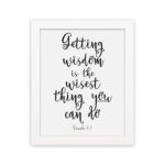 Wall art featuring the quote 'Getting wisdom is the wisest thing you can do' from Proverbs 4:7 on a white background. hung on the wall in a white frame