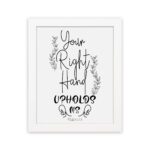 Wall art featuring the quote Your Right Hand Upholds Me from Psalm 63:8 in black text on a white background with floral designs hung on the wall in a white frame