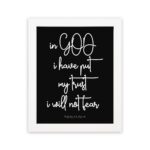 Christian wall art featuring Psalm 56:4 in bold white text on a black background. hung on the wall in a white frame