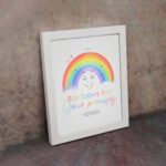 Cheerful rainbow wall art with the text Rainbows Are Your Promises in colorful letters, designed for kids' room decor. displayed on the wall in a white frame