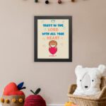 Cute teddy bear holding a heart with Trust in the Lord with all your heart text above, Proverbs 3:5 wall art design. displayed on the wall in a black frame