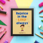 Rejoice in the Lord always, Philippians 4:4 Christian wall art with smiling child and bright colors. displayed on the wall in a black frame in a colorful background