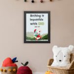 Wall art for kids featuring a happy cat in a Santa outfit holding a gift with the text Nothing is impossible with God. displayed on the wall in a black frame