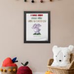 Cartoon elephant with a raised trunk and colorful text I Will Not Fear For God Is With Me - Isaiah 41:10) Bible Verse Wall Art. displayed on the wall in a black frame