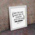 May The Lord Cause You To Flourish Both You And Your Children Psalm 115:14 Christian Wall Art with black text on white background. displayed on the wall in a white frame