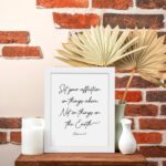 Set Your Affection on Things Above Colossians 3:2 Bible Verse Wall Art on a white background with black text and leaf decorations. displayed on the table in a white frame