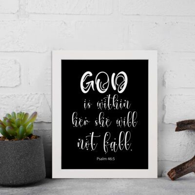 God Is Within Her, She Will Not Fall Psalm 46:5 Bible verse wall art in white text on a black background. displayed on the wall in a white frame