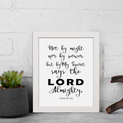 Not By Might Nor By Power Zechariah 4:6 Christian wall art with black text on a white background. displayed on the wall in a white frame