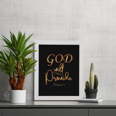 Infidu wall art with the text "GOD will provide" in gold font on a black background, referencing Philippians 4:19. displayed on the table in a white frame