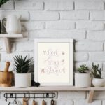 Cook Sing Dance kitchen wall art with pastel pink tones, a beige background, and musical notes.