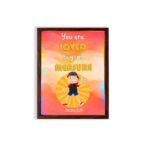 Colorful wall art featuring a happy child holding a heart with the quote You Are Loved Beyond Measure and Romans 8:38. hung on the wall in a brown frame