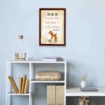 Artwork of a baby deer with flowers and the verse God knew me before I was born in warm colors. Perfect for children's decor. displayed on the wall in a brown frame