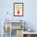 Cute teddy bear holding a heart with Trust in the Lord with all your heart text above, Proverbs 3:5 wall art design. displayed on the wall in a brown frame