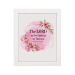 The Lord My God Lights Up My Darkness Psalm 18:28 Bible Verse Wall Art with black text on a soft pink watercolor background and delicate floral accents. Wall Art hung on the wall in white frame