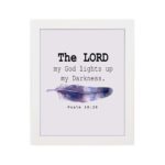 The Lord My God Lights Up My Darkness Psalm 18:28 Bible Verse Wall Art with black text and a purple and blue feather on a white background. Wall Art hung on the wall in a white frame