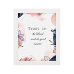 Trust In The Lord And Do Good Psalm 37:3 Bible Verse Wall Art with watercolor and floral designs on a white background. Wall Art hung on the wall in a white frame