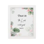 Trust in the Lord and Do Good Psalm 37:3 Bible Wall Art with botanical green leaves and pink flowers on a white background. Wall Art hung on the wall in a white frame