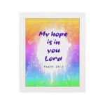 Infidu My Hope Is In You Lord Psalm 39:7 Bible Wall Art with bright blue and pink text and colorful watercolor background Wall Art hung on the wall in a white frame