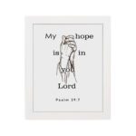 Infidu My Hope Is In You Lord Psalm 39:7 Bible Wall Art with a minimalist line drawing of figure in prayer and clean text Wall Art hung on the wall in a white frame