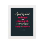 Infidu Psalm 46:1 Bible Wall Art with a deep blue background, pink and white text, featuring God is our refuge and strength. Wall Art hung on the wall in a white frame