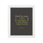 Psalm 46:1 Bible Wall Art with muted text on a dark gray background, featuring varying fonts and sizes. Wall Art hung on the wall in a white frame