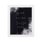 Be Still and Know That I Am God Psalm 46:10 Christian wall art with handwritten text on a navy blue background. wall art hung on the wall in a white frame