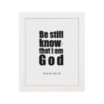 Be Still and Know That I Am God Psalm 46:10 Bible Verse Wall Art with bold black text on a white background. Wall Art hung on the wall in white frame