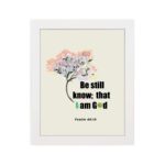 Be Still and Know That I Am God Psalm 46:10 Bible verse wall art with tree graphic, black and green text on a white background. hung on the wall in a white frame