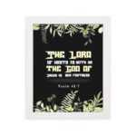 The Lord of Hosts is With Us Psalm 46:7 Bible Verse Wall Art with green leaves and bold cream and white text. hung on the wall in a white frame