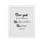 Bible verse wall art with Psalm 115:3 in black text on a white background. Modern design with cursive and standard fonts. hung on the wall in a white frame