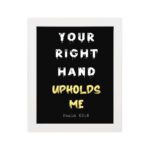 Infidu Your Right Hand Upholds Me Psalm 63:8 Bible Wall Art with a black background, yellow, and white font, and white frame hung on the wall