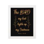 The Lord My God Lights Up My Darkness Psalm 18:28 gold text on black background Christian wall art hung on the wall in a white frame