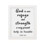 Psalm 46:1 Bible wall art with black bold text on a white background, saying 'God is our refuge and strength, a very present help in trouble. Wall Art hung on the wall in a white frame