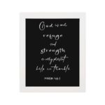 Psalm 46:1 Bible wall art with white text on black background, saying 'God is our refuge and strength, a very present help in trouble. Wall Art hung on the wall in a white frame