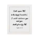 Psalm 50:15 Bible wall art with black text on white background, saying 'Call upon Me in the day of trouble; I will deliver you. Wall Art hung on the wall in a white frame