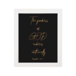 Psalm 52:1 The Goodness of God Endures Continually Bible verse wall art with gold text on a black background. Wall Art hung on the wall in a white frame