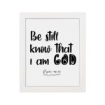 Be Still and Know That I Am God Psalm 46:10 Bible Verse Wall Art with black text on a white background Wall Art hung on the wall in a white frame