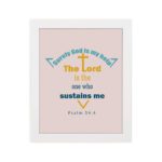 Surely God Is My Help - Psalm 54:4 Bible Verse Wall Art with Colorful Fonts and Cross Symbol on Soft light pink Background Wall Art hung on the wall in a white frame