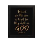 Infidu wall art with the text Blessed are the pure in heart, for they shall see God in gold font on a black background. hung on the wall in a black frame