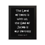 The Lord Of Hosts Is With Us - Psalm 46:7 Bible Verse Wall Art with White Text on Black Background Wall Art hung on the wall in a black frame