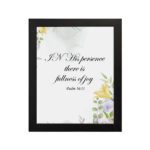 In His Presence There Is Fullness of Joy - Psalm 16:11 Bible Verse Wall Art with Pastel Floral Design on White Background Wall Art hung on the wall in a black frame